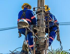 line workers in buckets at utility pole